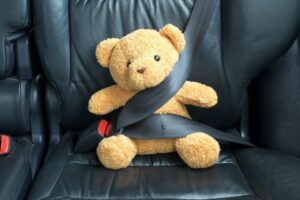 The image of teddy doll putting seatbelt in car at Henderson, NV