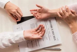 no fault divorce concept of couple holding wedding rings with divorce decree