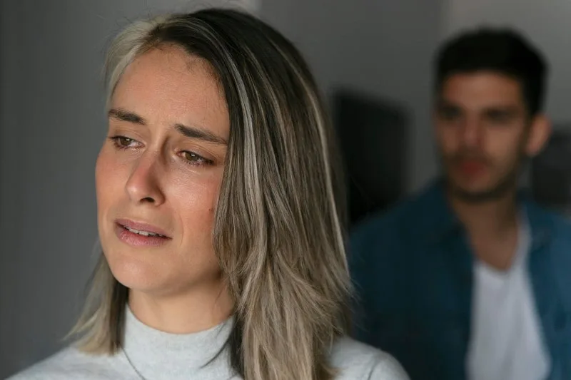divorce concept of upset wife suspecting her husband is hiding criminal activities from her