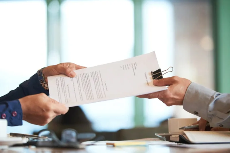 legal concept of a petition for a legal action as shown by two parties exchanging a document